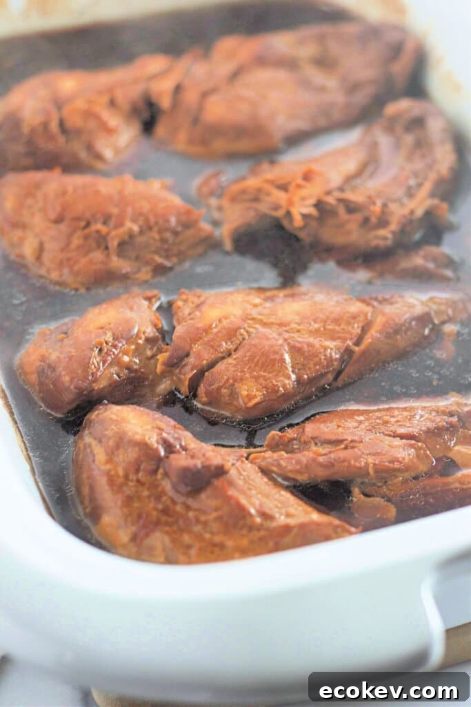 Cooked meat in a crock pot.