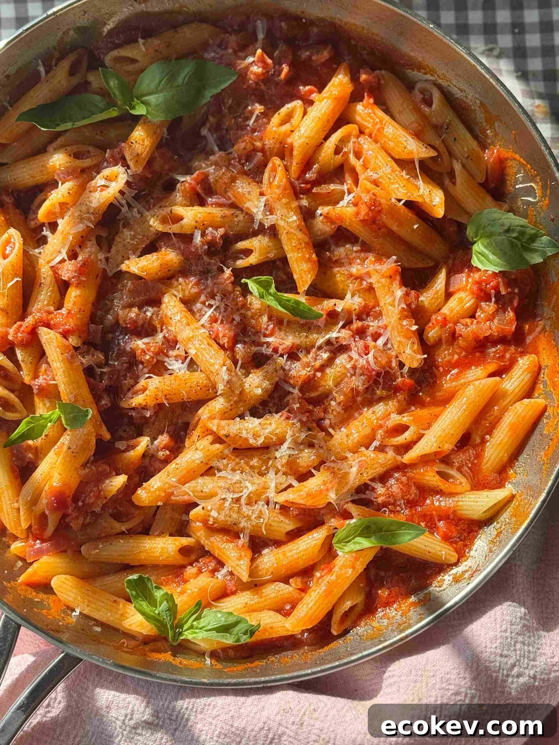 penne amatriciana in a silver pan.