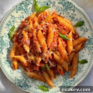 penne amatriciana in a blue bowl.