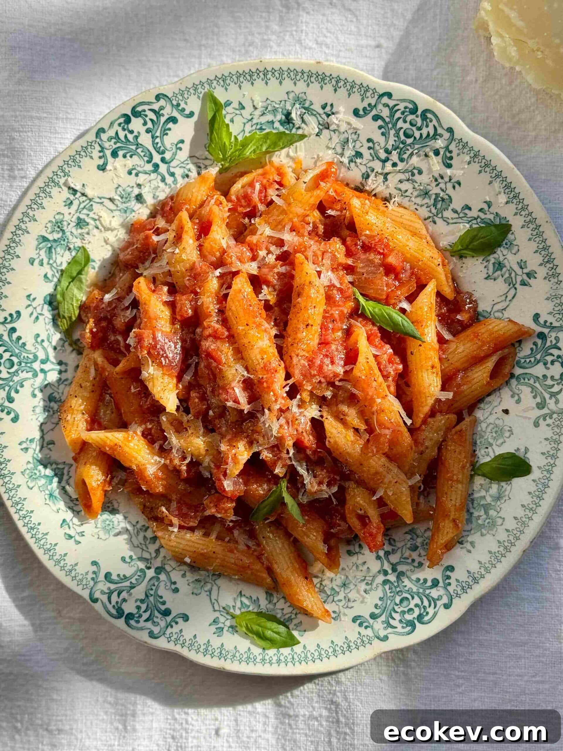 penne amatriciana in a blue bowl.