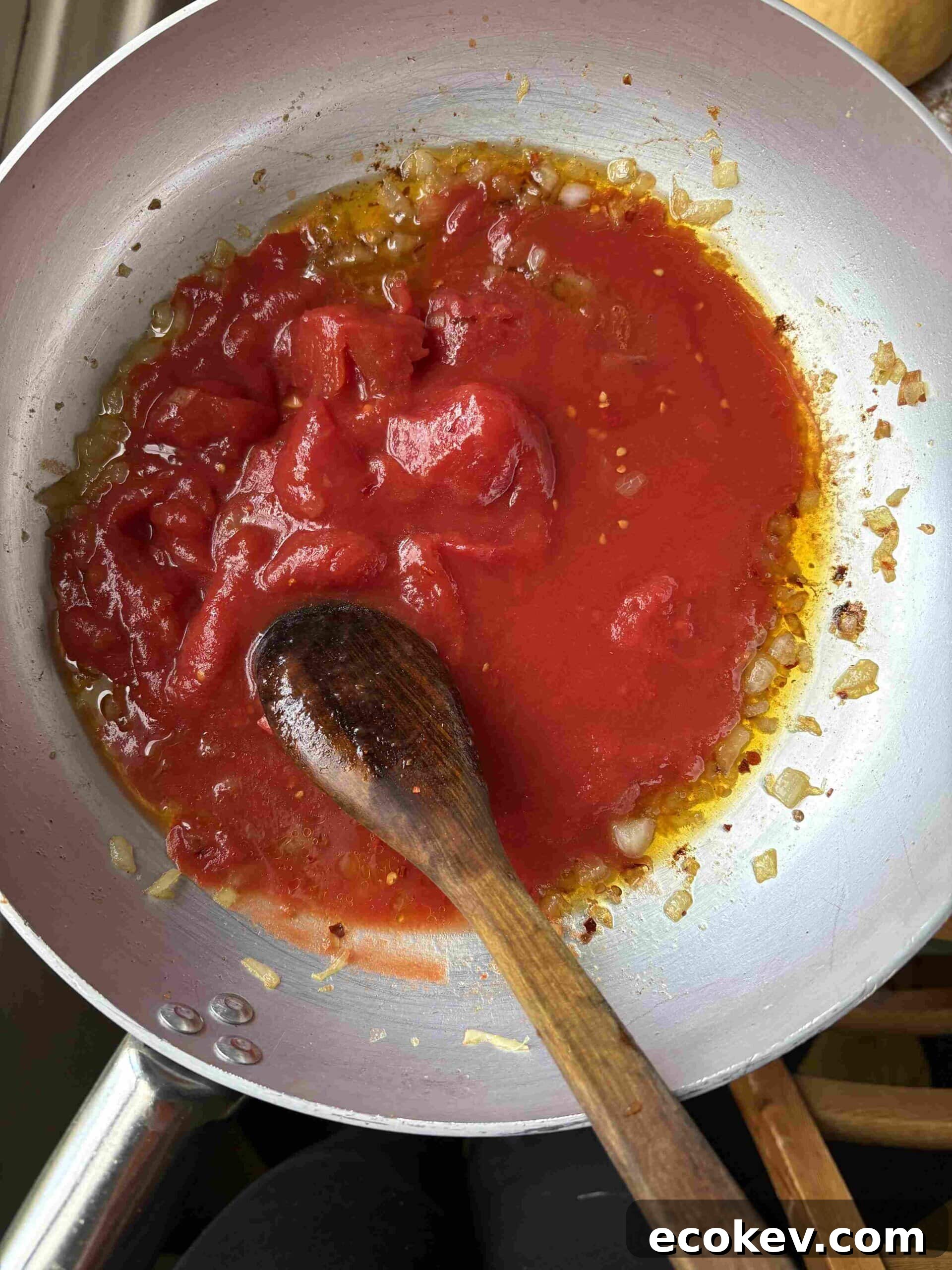 adding tomatoes to amatriciana.