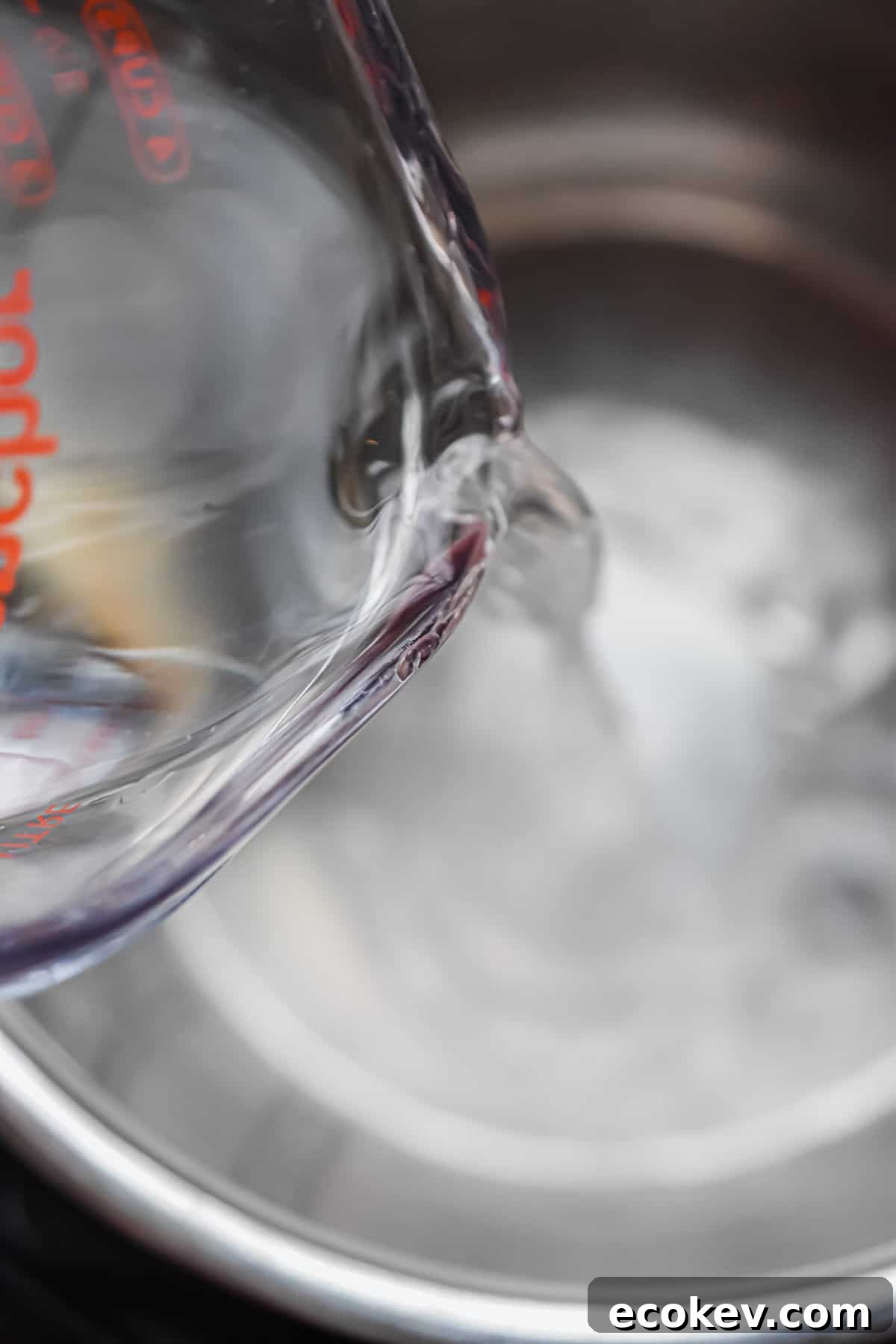 The water is being poured into the Instant Pot.