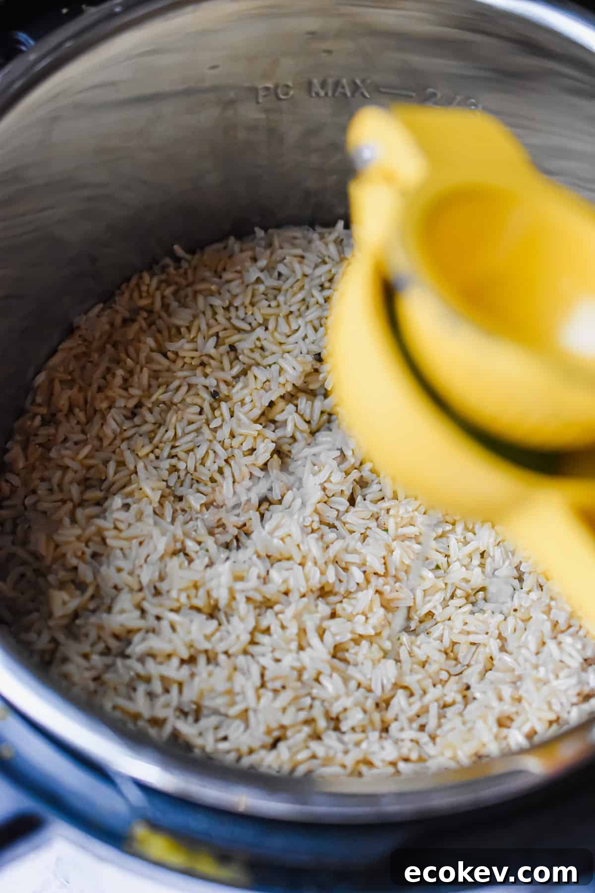 A citrus squeezer is squeezing lime into the Instant Pot.