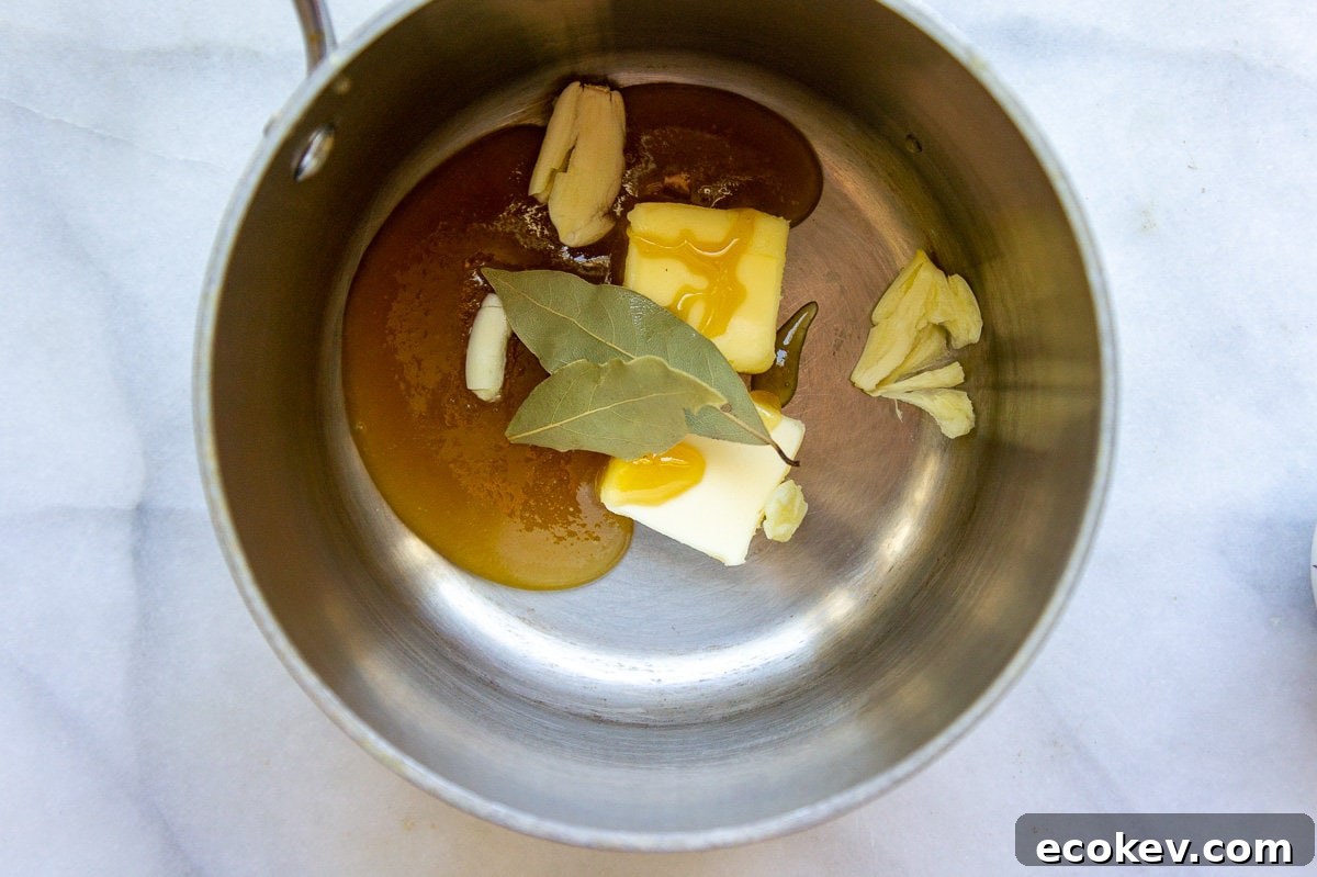a saucepan with honey, sage, butter, and garlic inside.