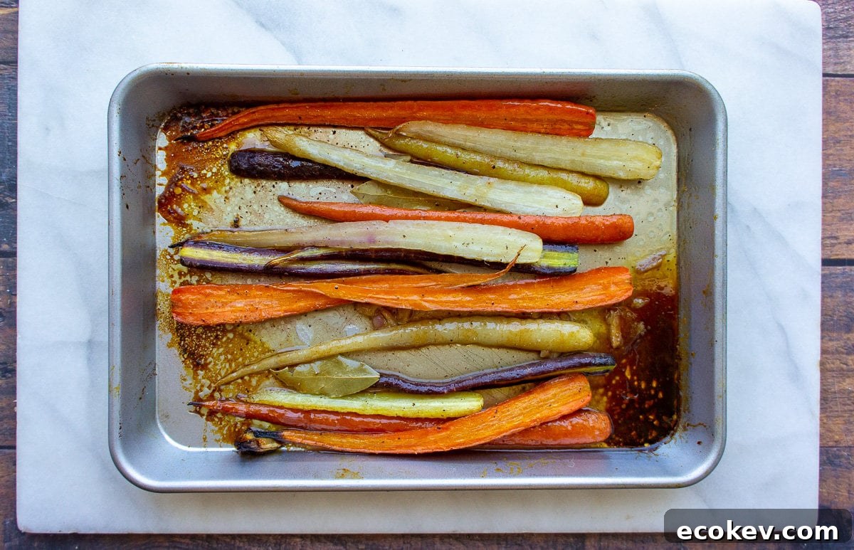 a metal pan with roasted rainbow carrots in it.
