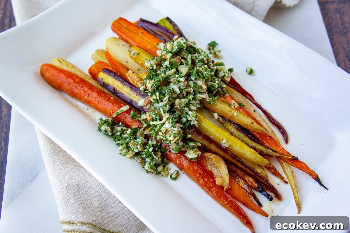 a platter of roasted glazed rainbow carrots topped with gremolata.