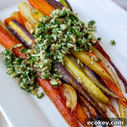 a platter of roasted glazed rainbow carrots topped with gremolata.