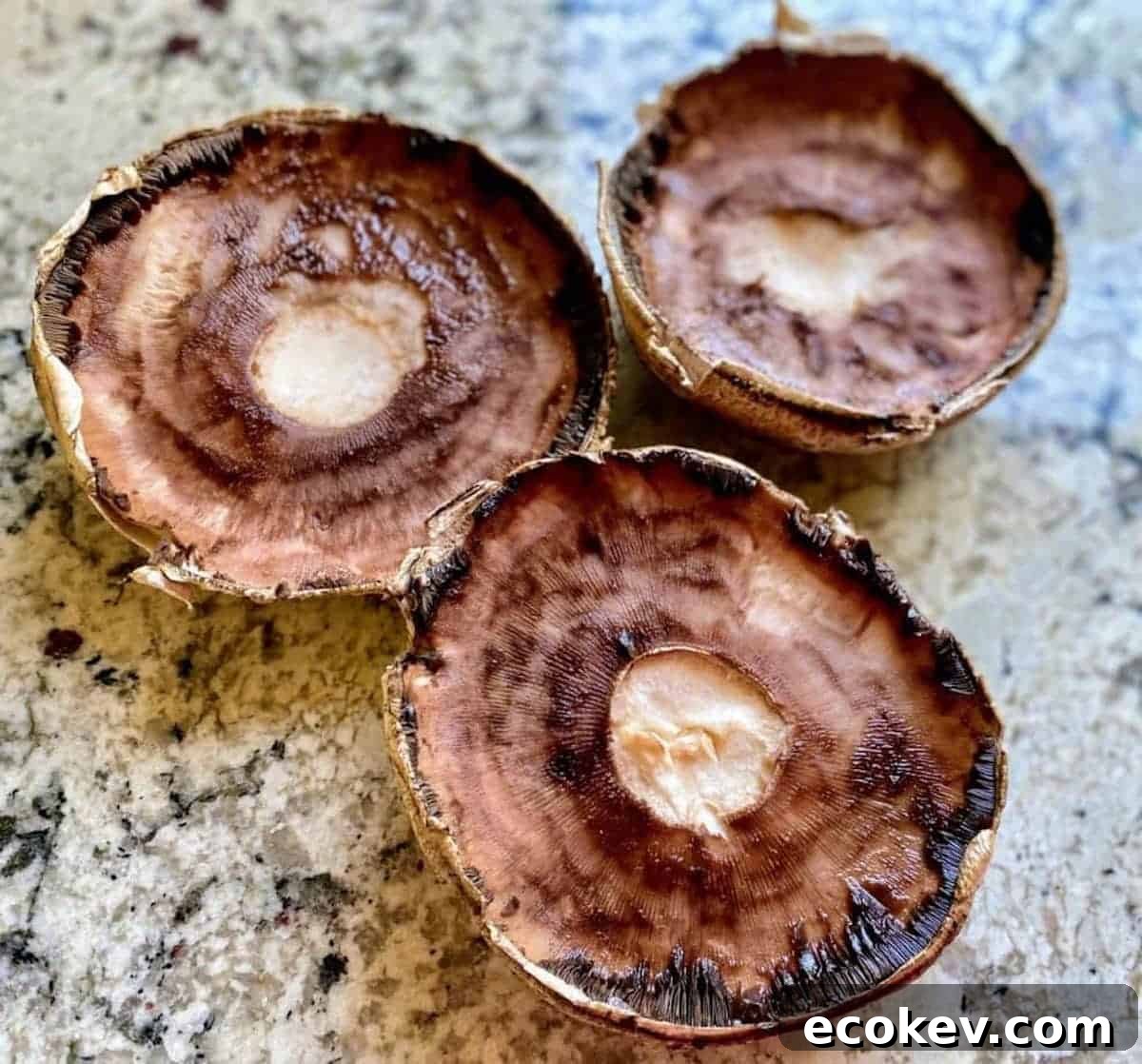 Portobello mushrooms cleaned on the counter.
