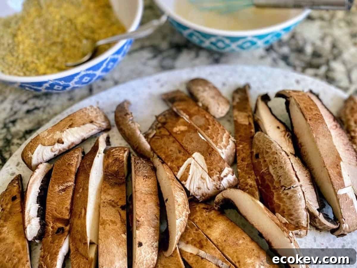 Cut mushroom fries with two bowls; one with milk and mustard, the other bowl with breadcrumbs and nutritional yeast.