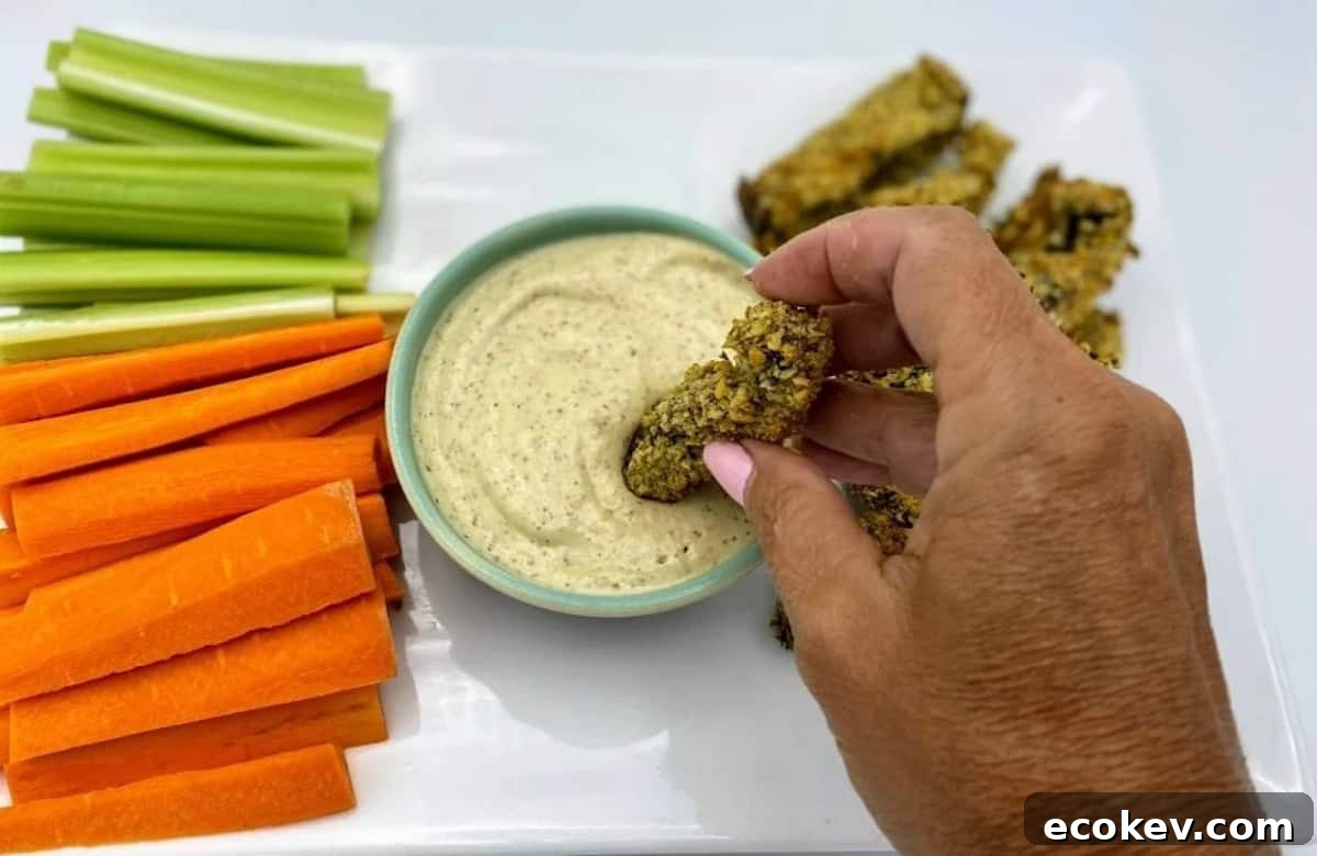 Dipping portobello mushroom fries in dip.