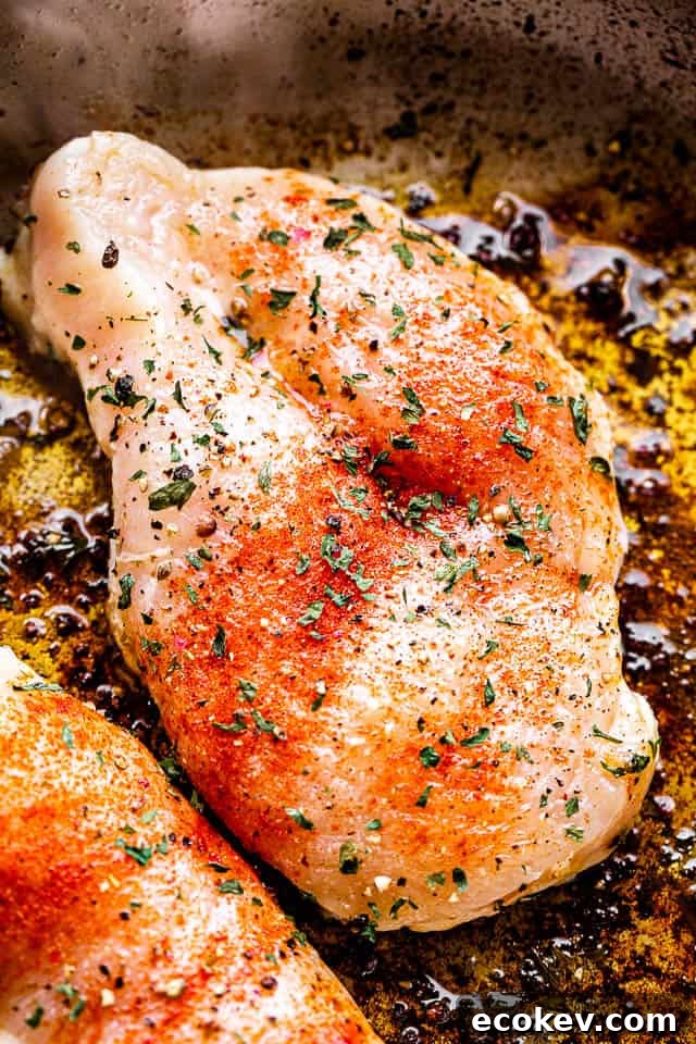 searing chicken breasts in a skillet