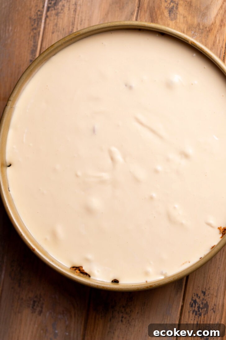 Cheesecake batter on top of apple filling.