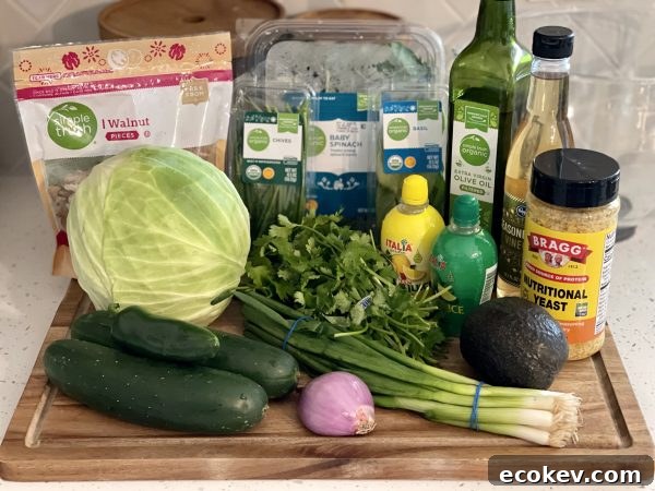 All the ingredients needed for Tiktok's Green Goddess Salad on a wood cutting board.