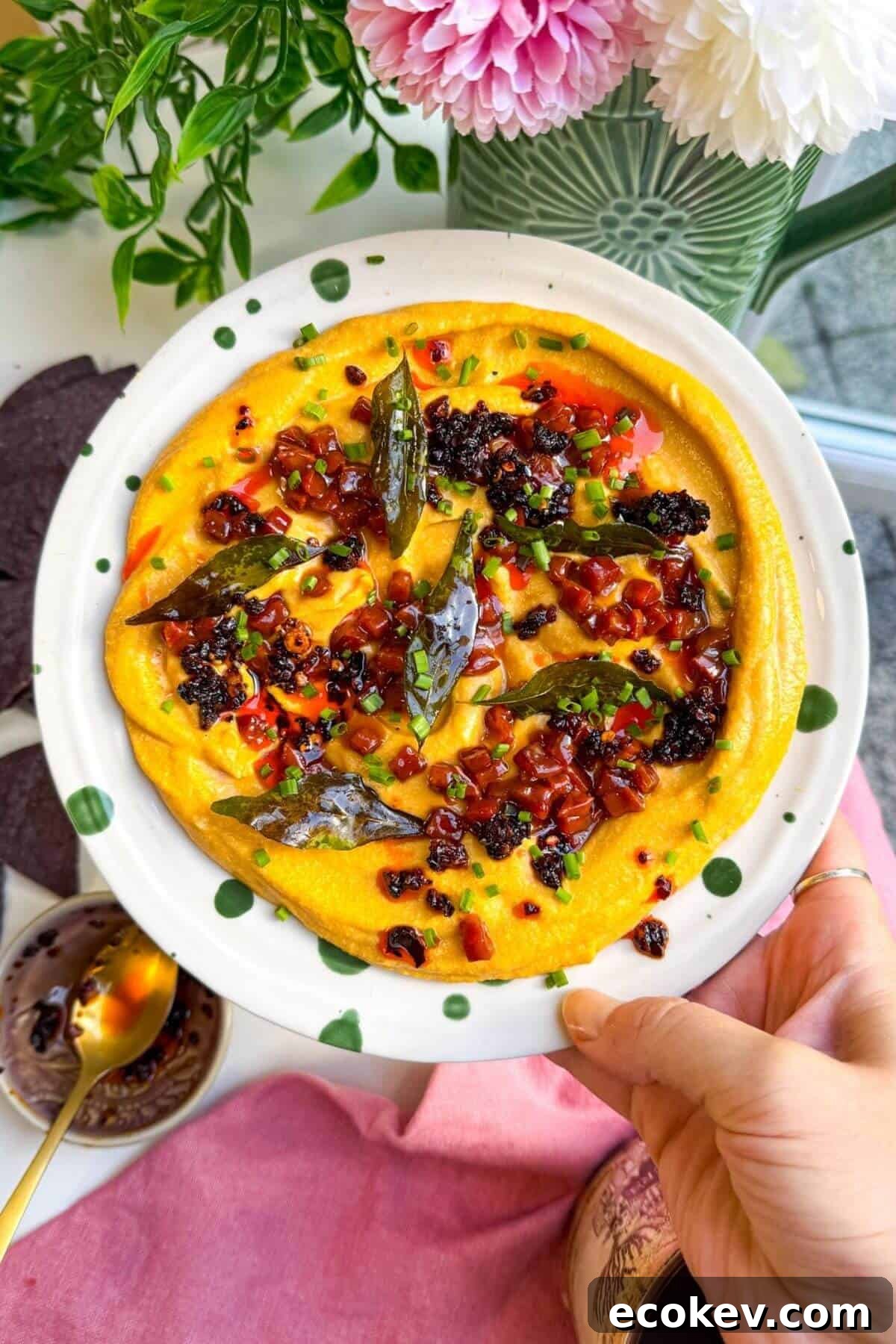 Butternut squash feta dip topped with chorizo, chili crisp and curry leaves.