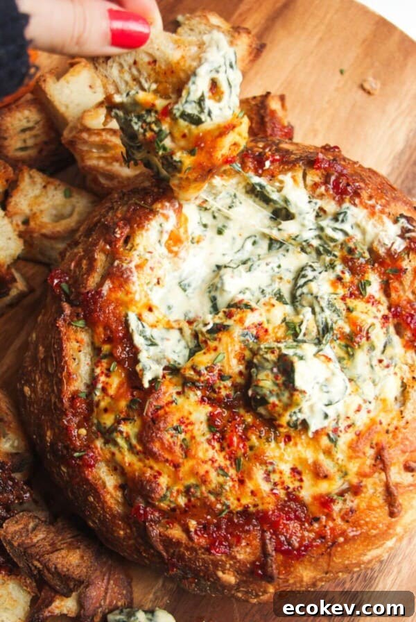 Cheesy spinach dip in a bread bowl.