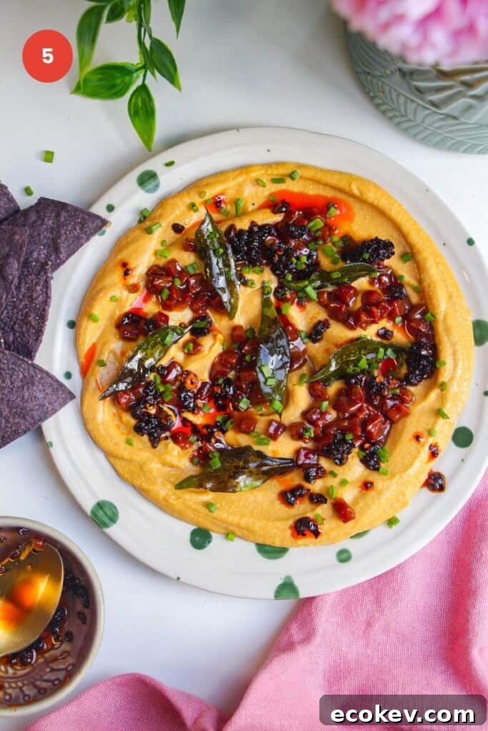 Butternut squash feta dip topped with chorizo, chili crisp and curry leaves.