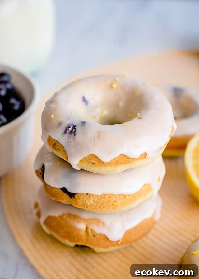 stack of donuts on a yellow place mat with lemon and donuts around it
