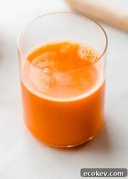 A glass of orange carrot and ginger juice