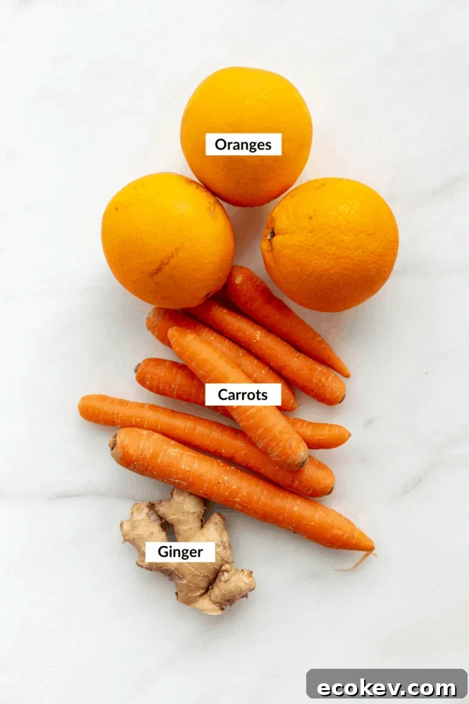 oranges, carrots and ginger on a marble board