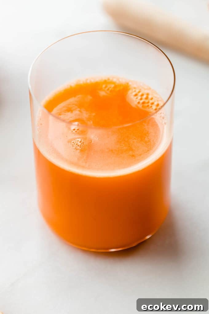 A glass of orange carrot and ginger juice