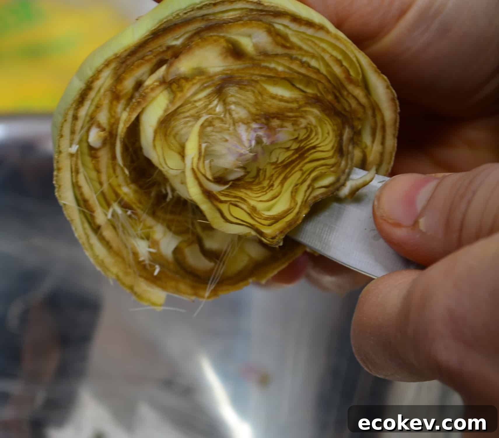 Removing the inside fuzz of a fresh artichoke heart