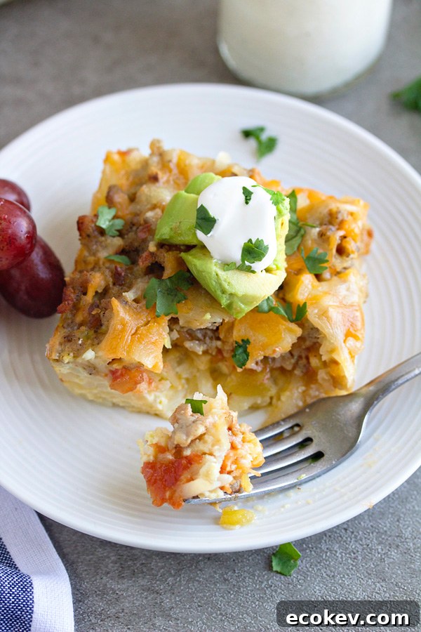 A slice of Mexican breakfast casserole on a white plate