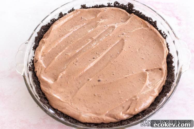 creamy chocolate mousse in oreo cookie crust in glass deep dish pie plate