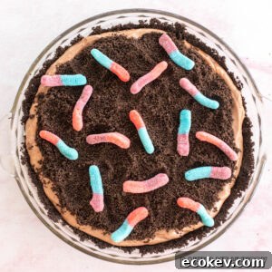 mud pie recipe with gummy worms shown from overhead in glass pie plate
