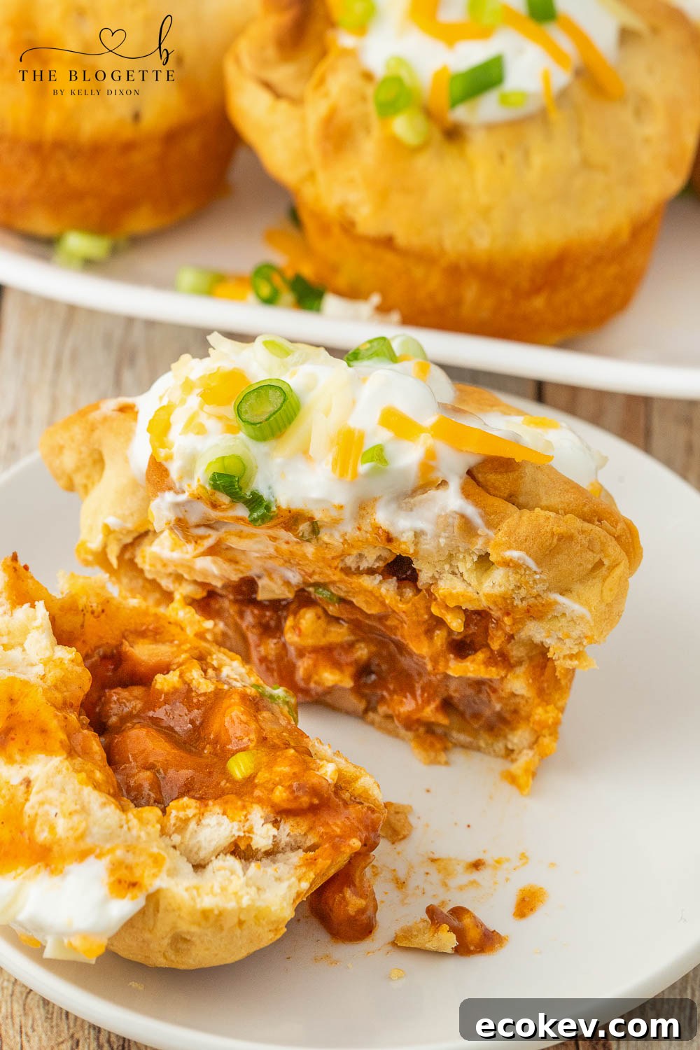 Chili stuffed rolls! Buttery biscuits surrounding chili and cheese, topped with sour cream and green onions.