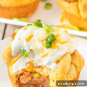 Chili stuffed rolls! Buttery biscuits surrounding chili and cheese, topped with sour cream and green onions.