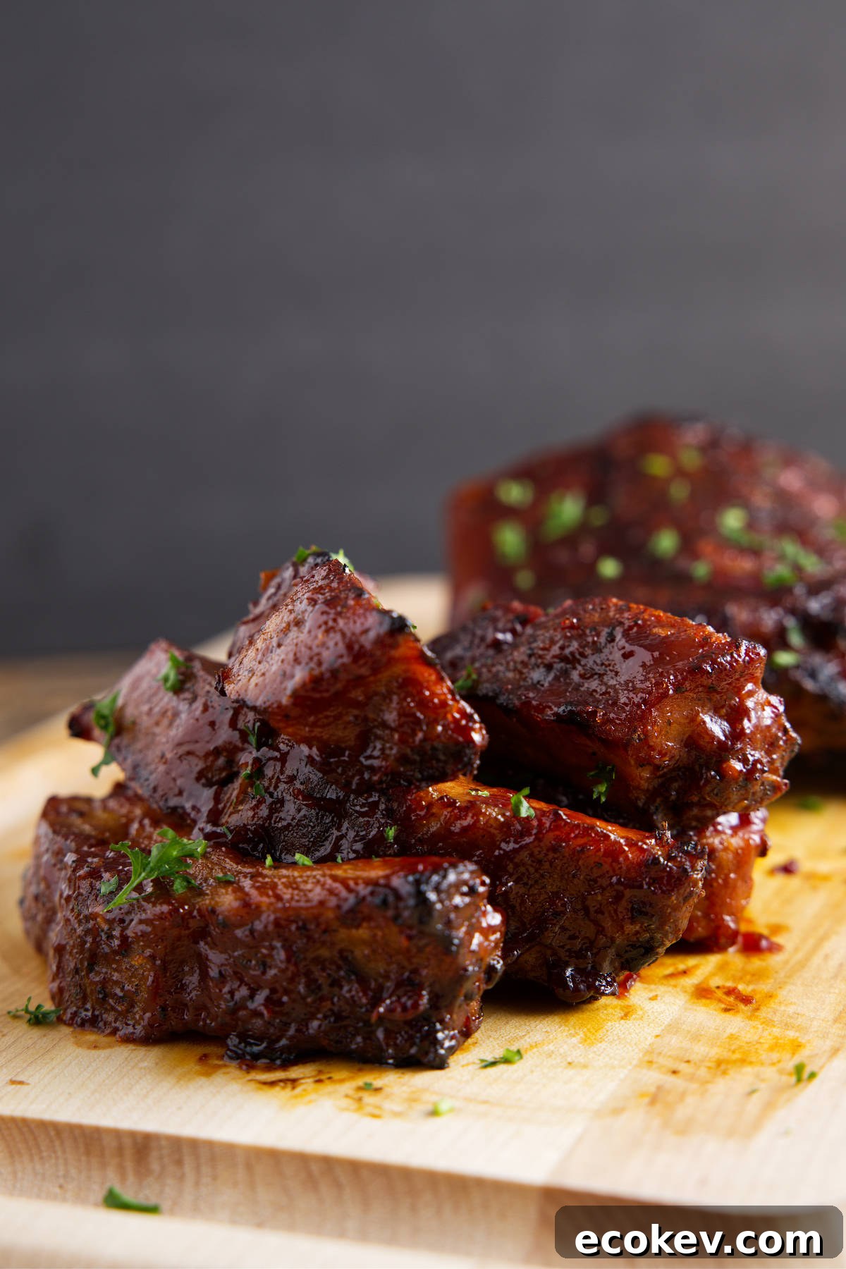 Saucy pork ribs reheated in the air fryer and resting on a cutting board.
