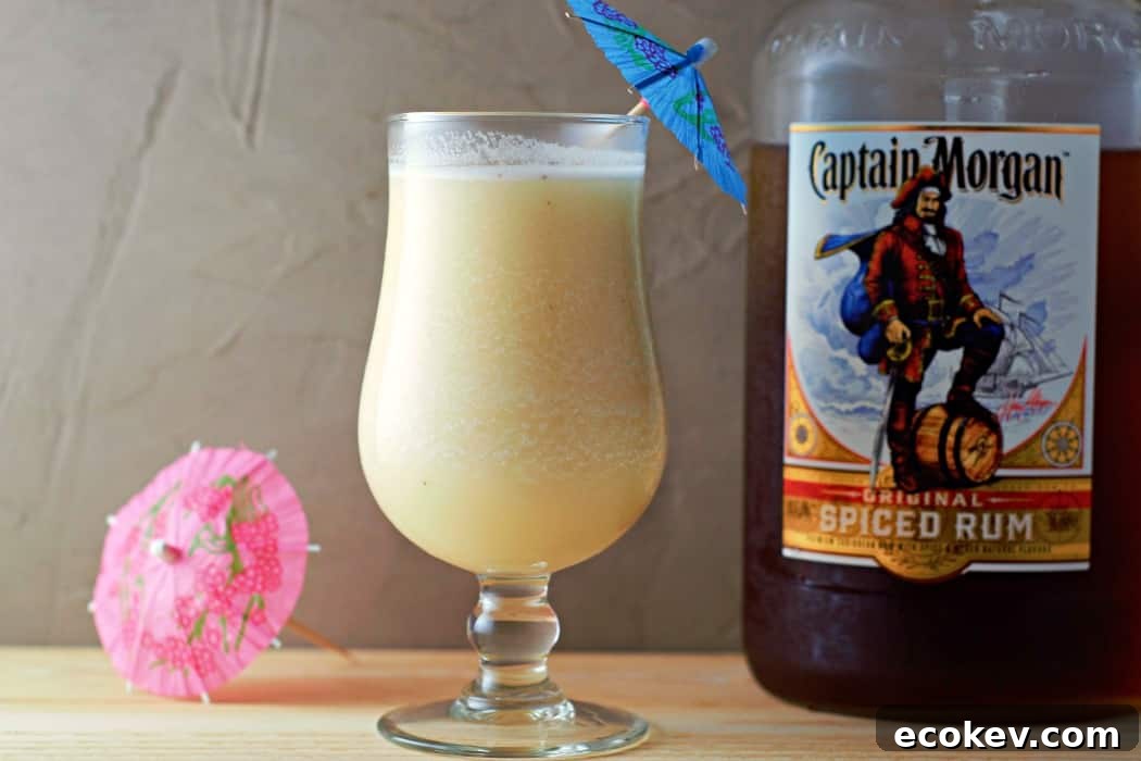 a Banana Daiquiri next to a bottle of Captain Morgan Spiced Rum.