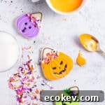 three treat bucket cookies on an off-white backdrop with sprinkles and icing along the sides