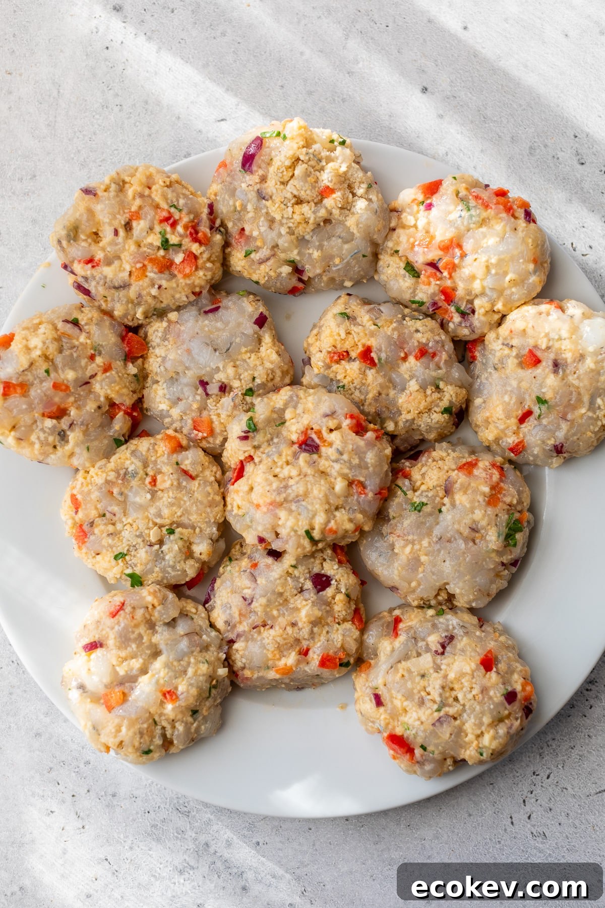 shrimp cakes formed and placed on a plate