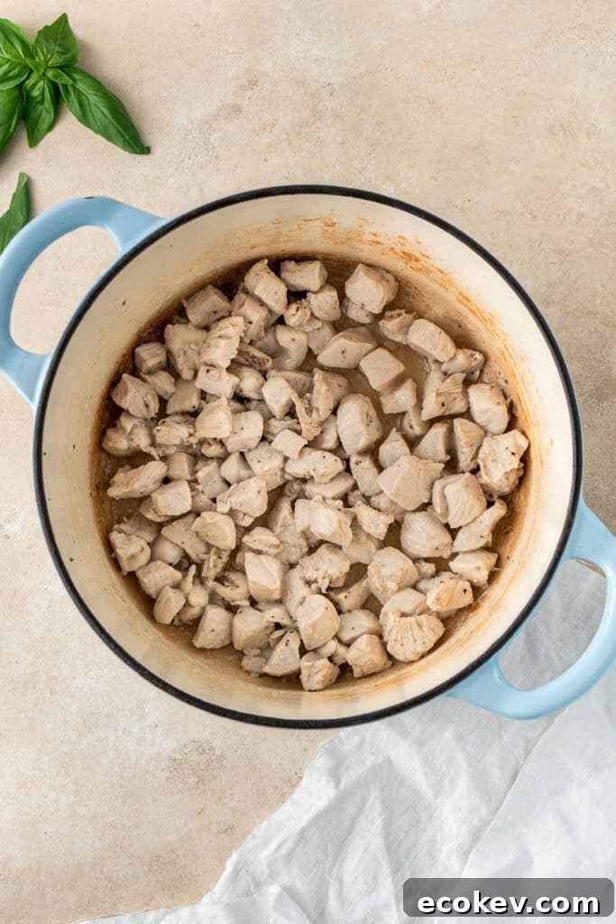 Cooking the chicken in the pot.