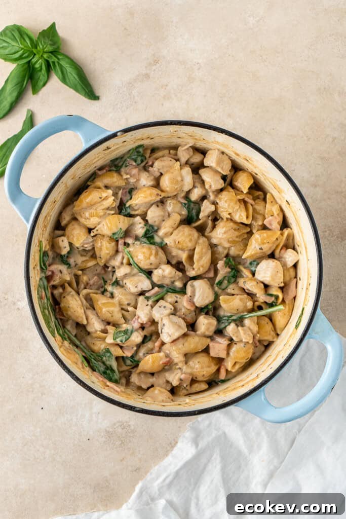 Creamy chicken and bacon pasta in a pot.