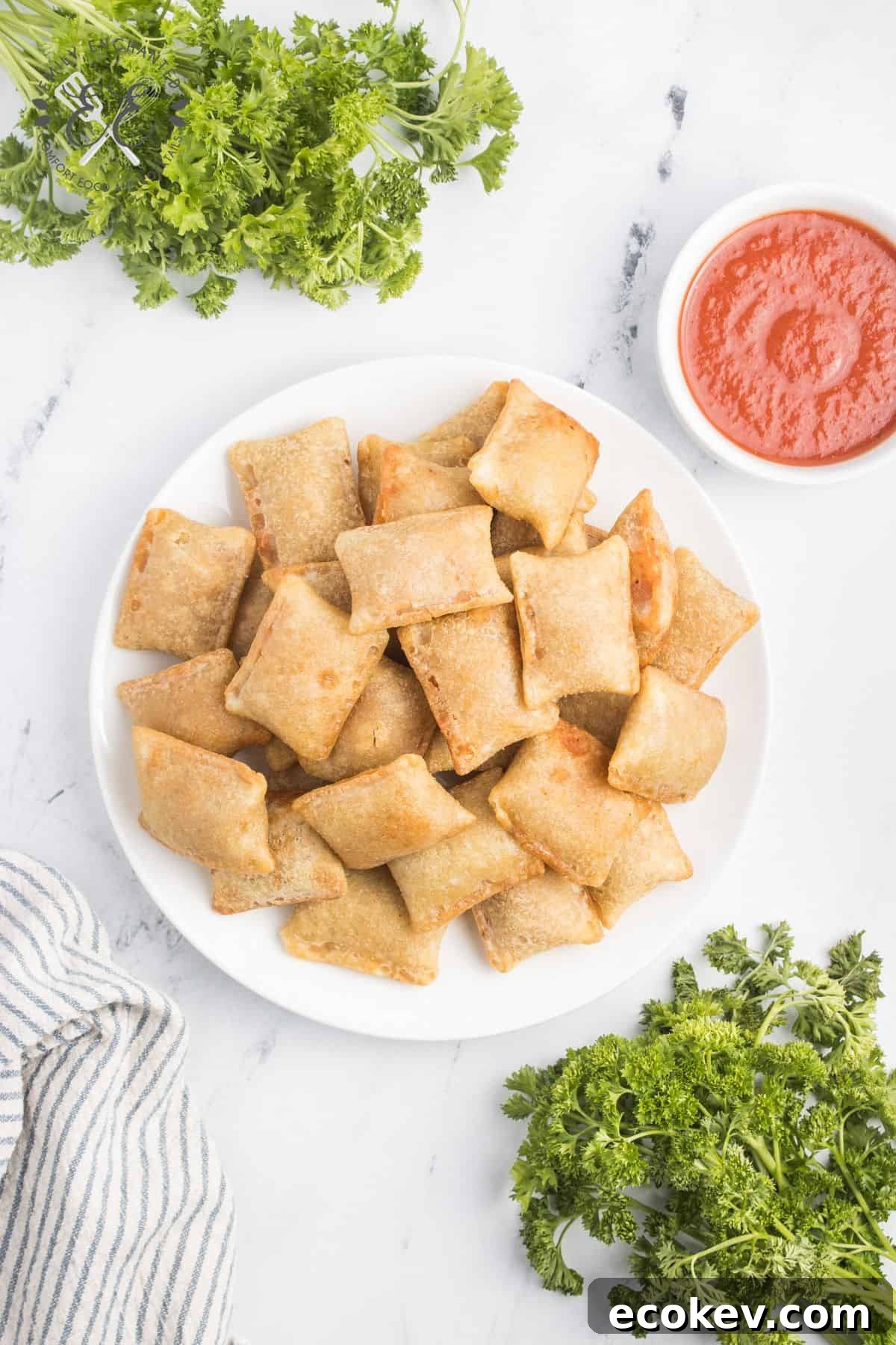 Air Fryer Pizza Rolls on a plate with a bowl of marinara dipping sauce