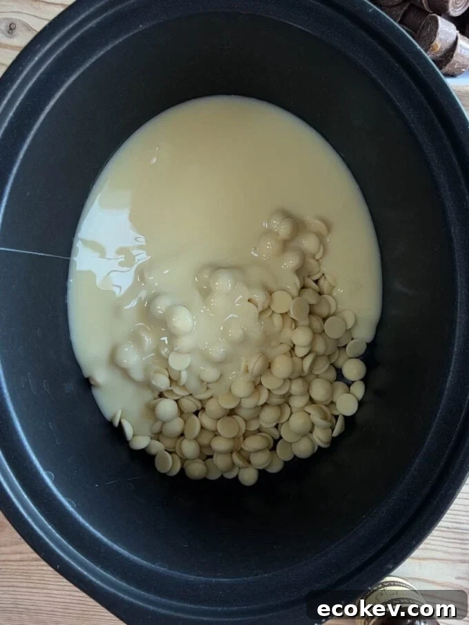 A slow cooker with white chocolate and condensed milk. Rolo Fudge recipe. Step 1.