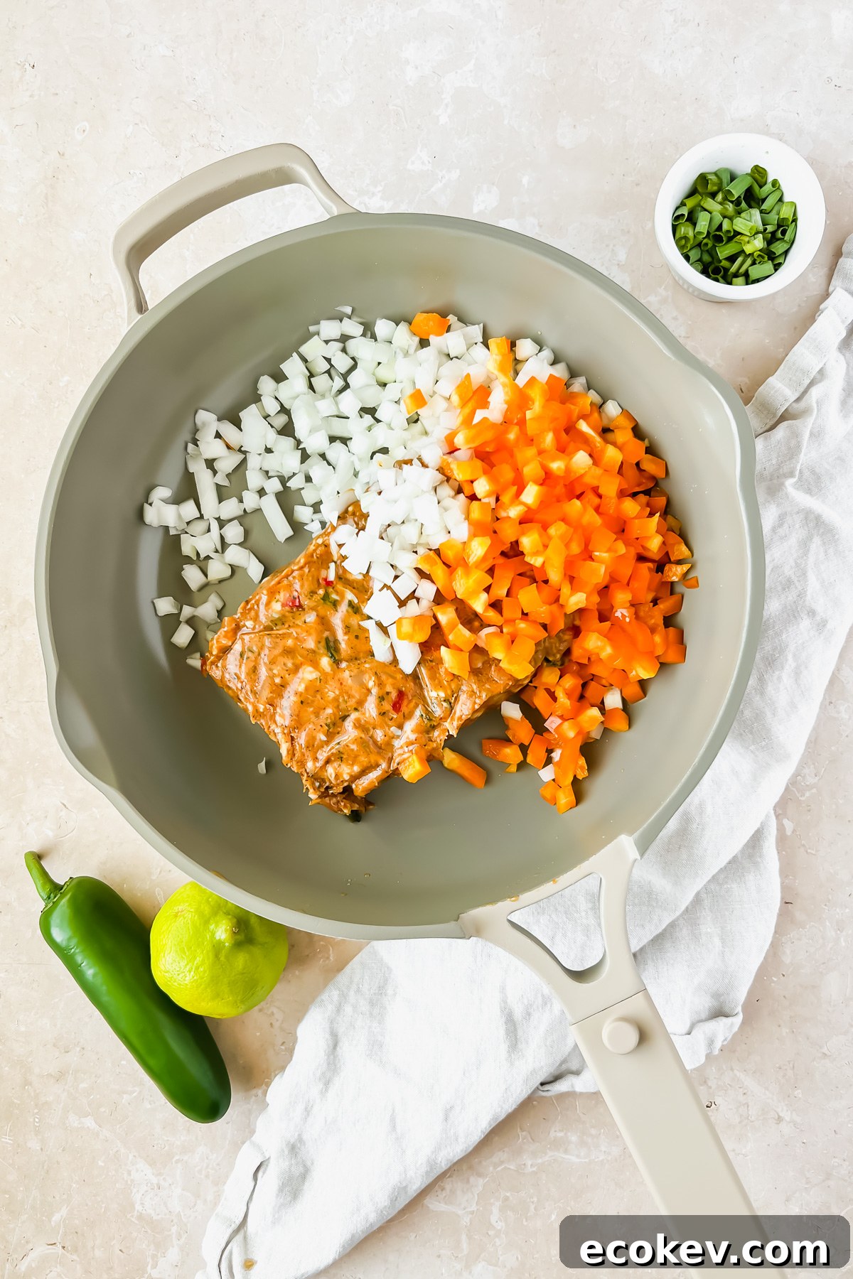 Raw ground chicken and vegetables in skillet