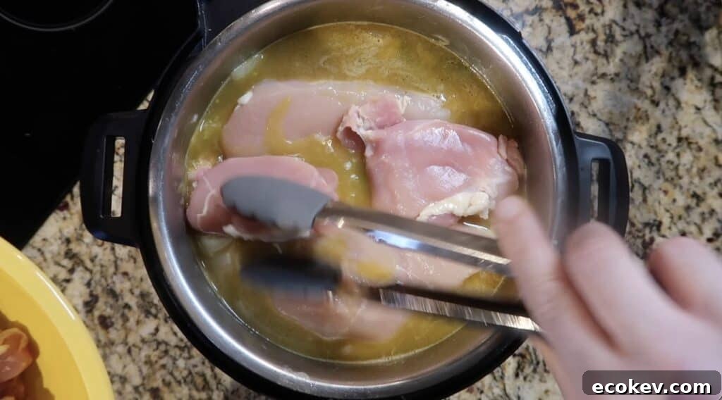 Adding chicken to pot