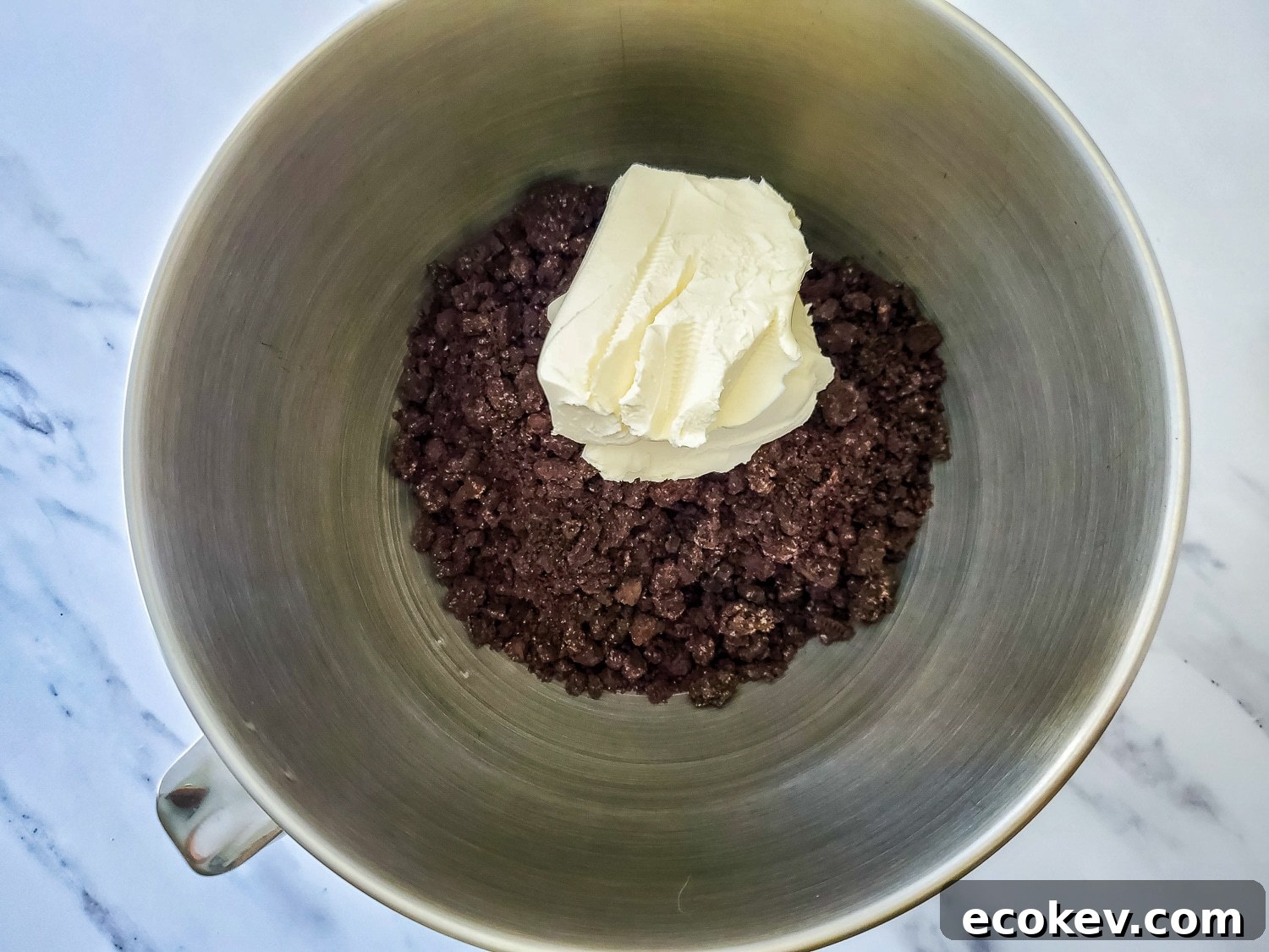 mixing Oreo crumbs and cream cheese