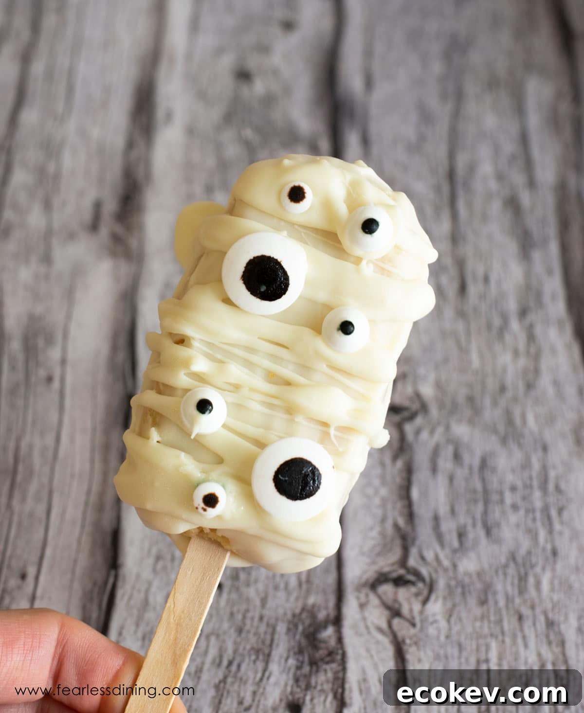 Holding up a white mummy cakesicle.