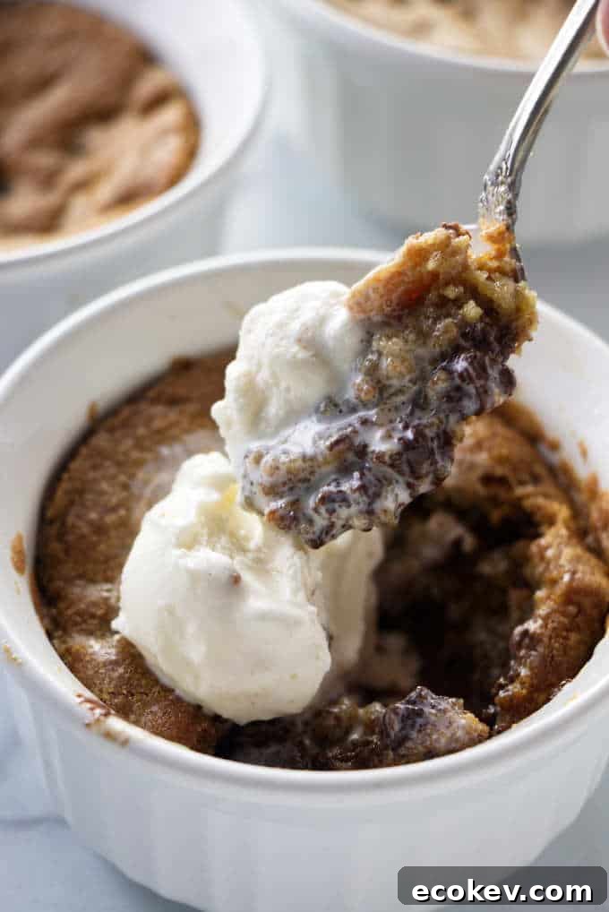 A spoon scooping into a deep dish cookie bowl.