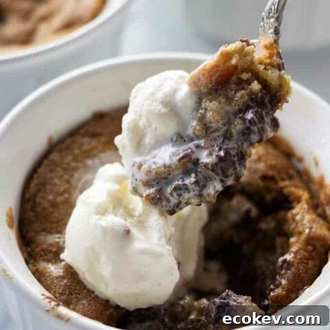 A spoon scooping into a deep dish cookie bowl.