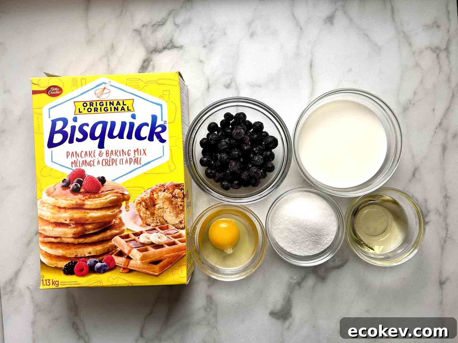 Fluffy Bisquick Muffins Recipe 3 Box of Bisquick next to other ingredients in bowls.