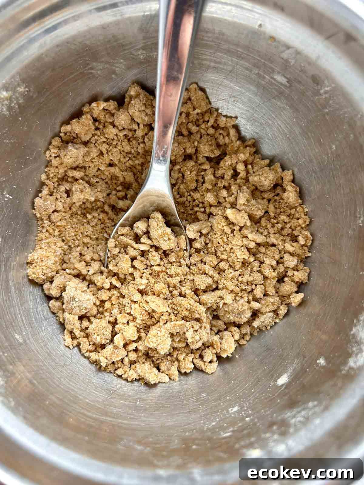 Fluffy Bisquick Muffins Recipe 6 brown sugar streusel being made in small bowl.