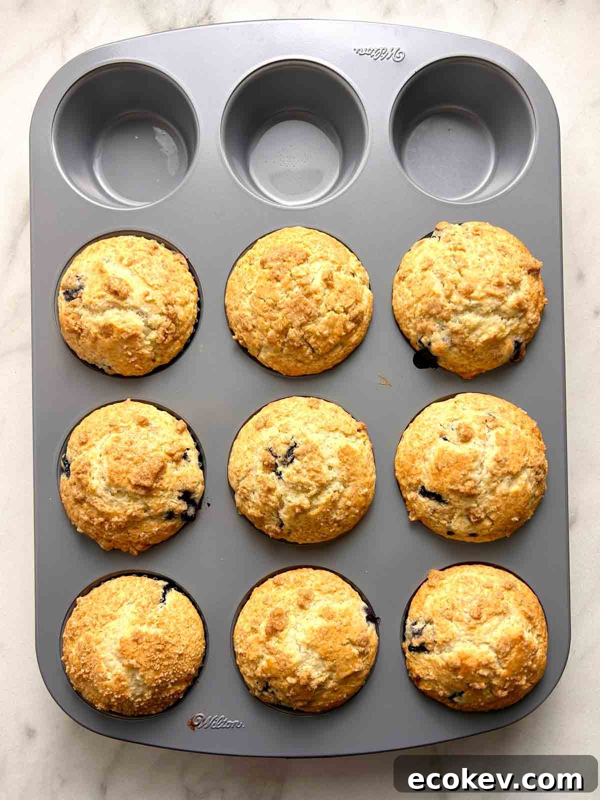 Fluffy Bisquick Muffins Recipe 7 overhead shot of baked muffins in muffin tray.