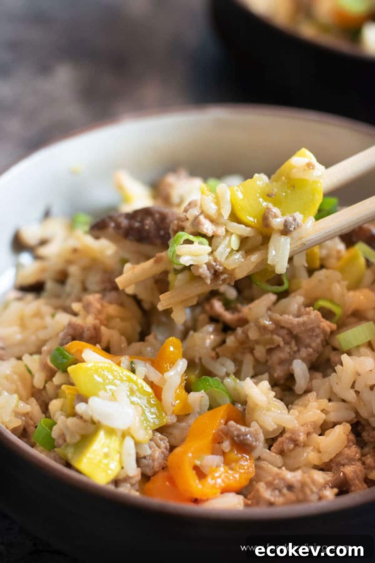 Holding up some of the fried rice between chopsticks.